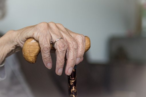 care homes for elderly woman holding walking stick